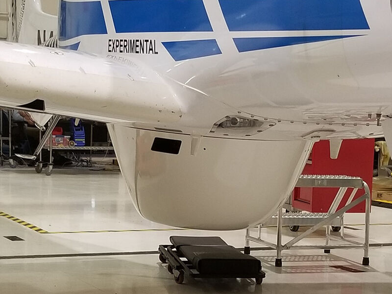 Image of a commercial aircraft in a manufacturing environment with RWC's low-loss RF radome installed on the belly. 
